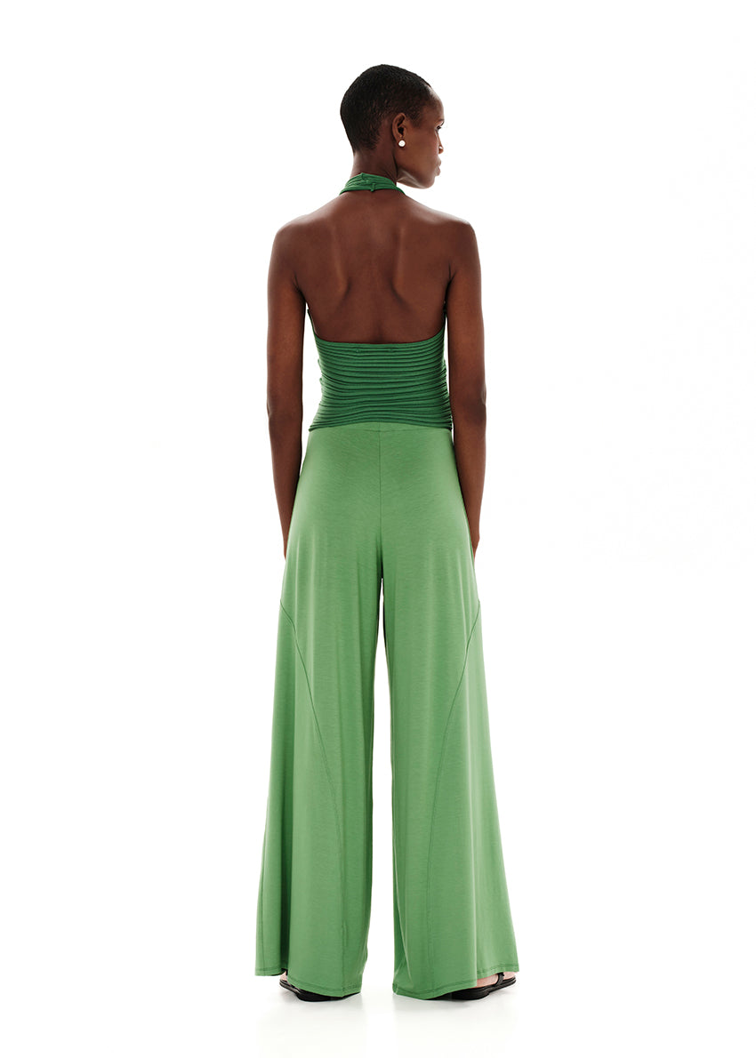 Knitted green crop top with a twist at the bust, halter neckline and an open back.Knitted crop top in a form – fitting silhouette.It has a twist in the bust area, a halter neckline with a subtle ‘V’ and an open back