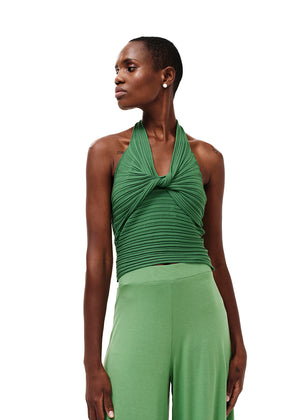 Knitted green crop top with a twist at the bust, halter neckline and an open back.Knitted crop top in a form – fitting silhouette.It has a twist in the bust area, a halter neckline with a subtle ‘V’ and an open back