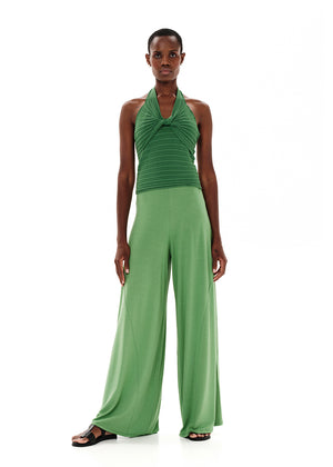 Knitted green crop top with a twist at the bust, halter neckline and an open back.Knitted crop top in a form – fitting silhouette.It has a twist in the bust area, a halter neckline with a subtle ‘V’ and an open back