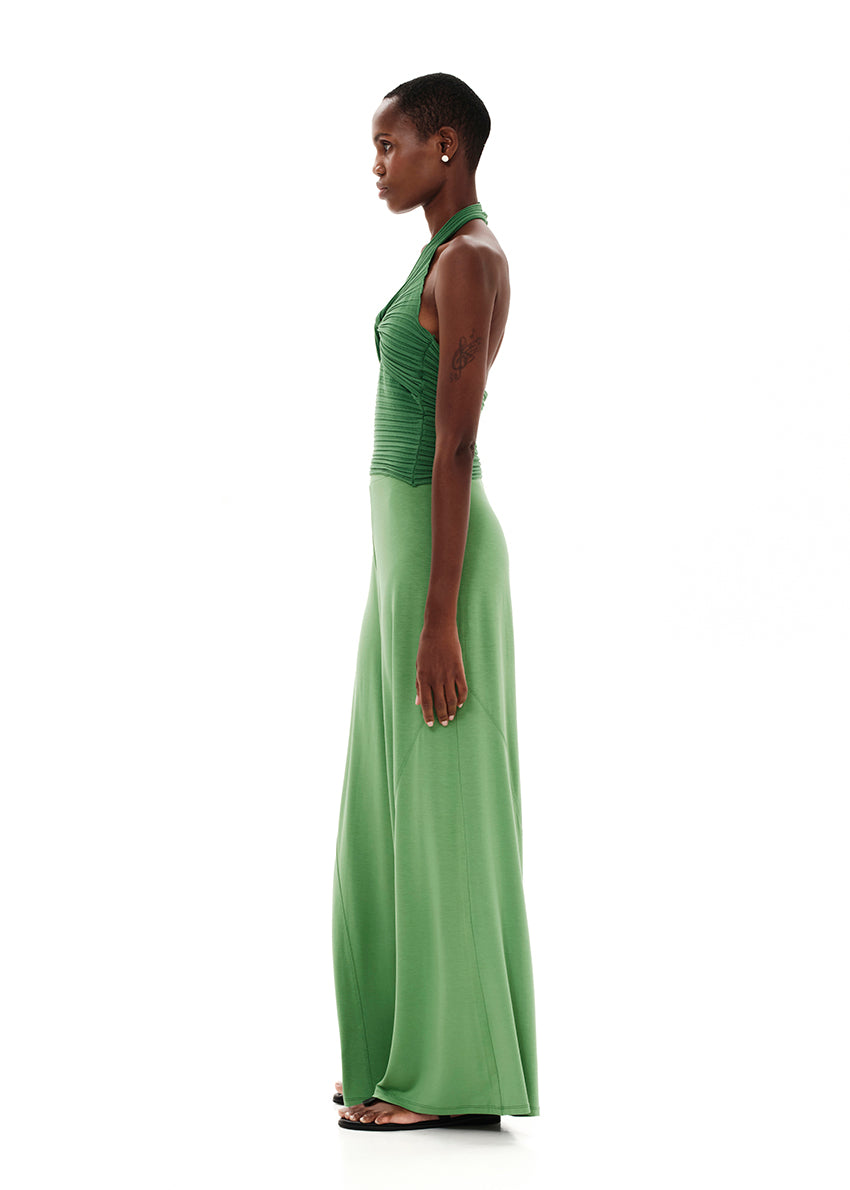Knitted green crop top with a twist at the bust, halter neckline and an open back.Knitted crop top in a form – fitting silhouette.It has a twist in the bust area, a halter neckline with a subtle ‘V’ and an open back