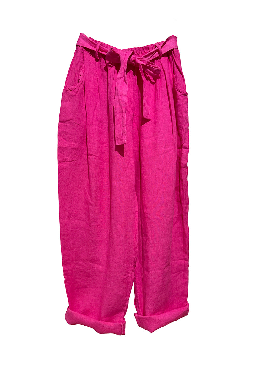 A pair of deep pink linen pants with an adjustable tie-waist design.