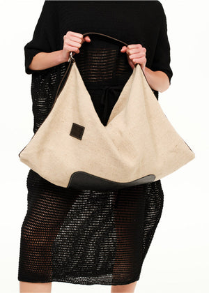 Summer style with our oversized shoulder bag, crafted from premium artificial leather and straw.