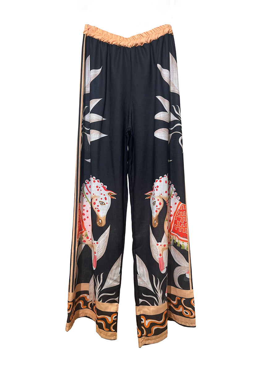 Black pants with colorful animal print on a white background