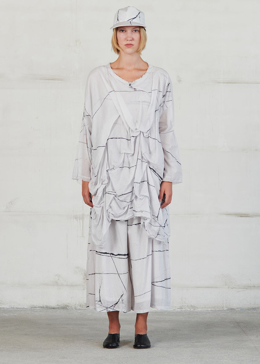 Asymmetrical, long white sleeve blouse in oversized fit, with large ruffles on the front side and round neck