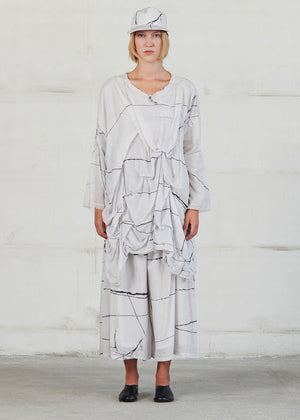 Asymmetrical, long white sleeve blouse in oversized fit, with large ruffles on the front side and round neck