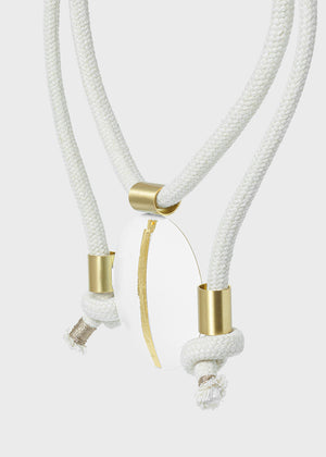 White rope with gold metal clasps on a light gray background