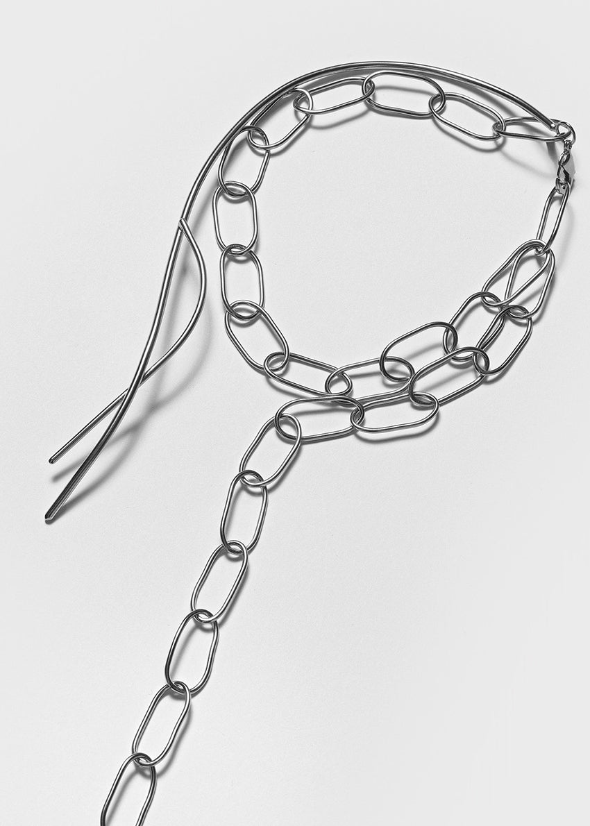 Metal chain with a hair clip on a white background