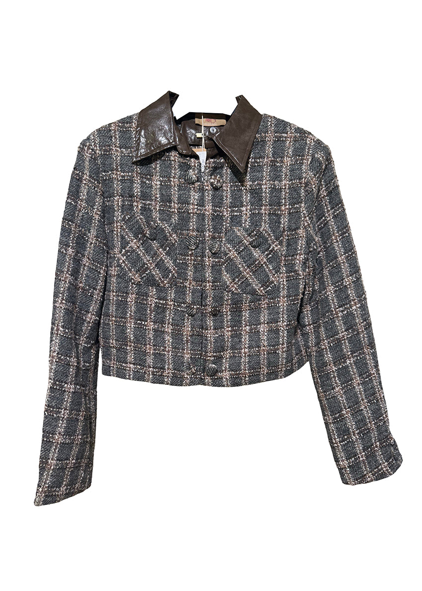 Cropped plaid jacket. The standout feature is its removable leather collar—securely attached with buttons. The jacket’s textured fabric is woven with a subtle, light-reflecting fiber. Metallic hoops, adding a vintage-inspired twist. Double front pockets and covered buttons