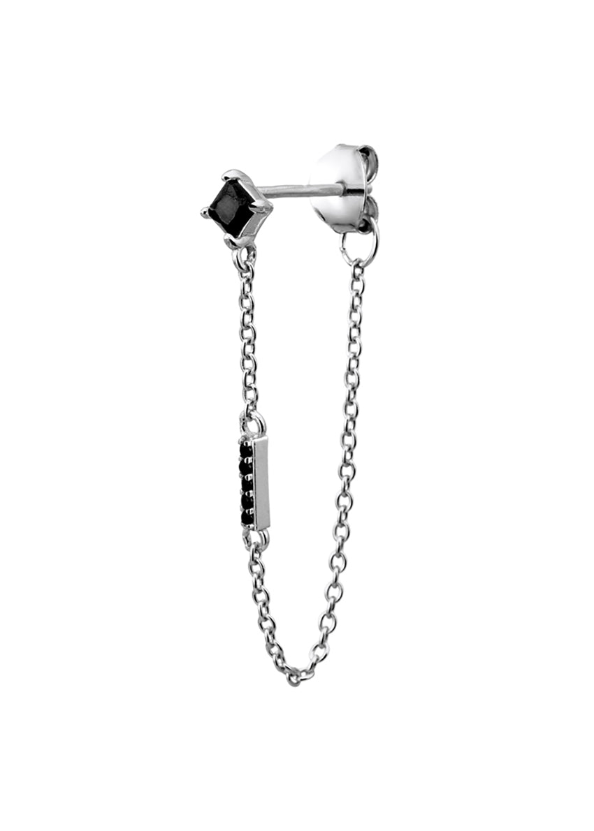 A single earring featuring a black stone stud attached to a small chain with a rhodium-plated silver rod.