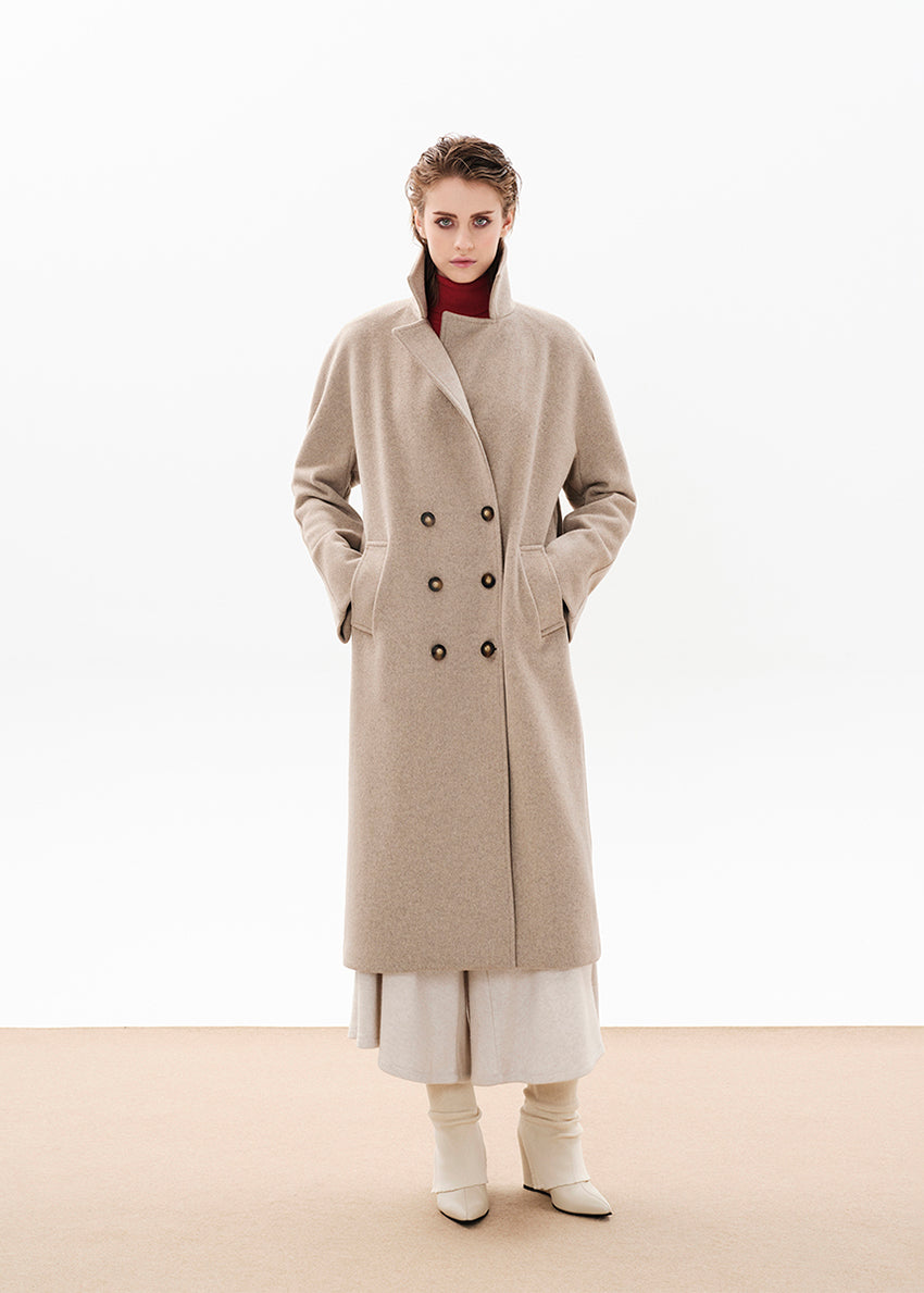 Person wearing a beige wool coat on a white background 