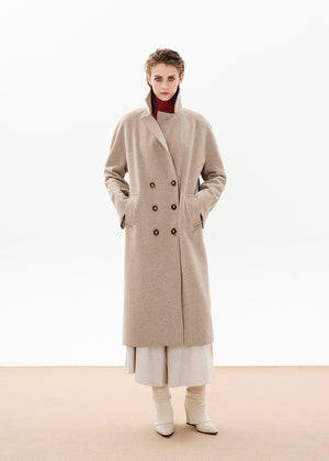 Person wearing a beige wool coat on a white background 
