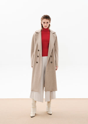 Person wearing a beige wool coat with a red sweater and white pants on a white background 