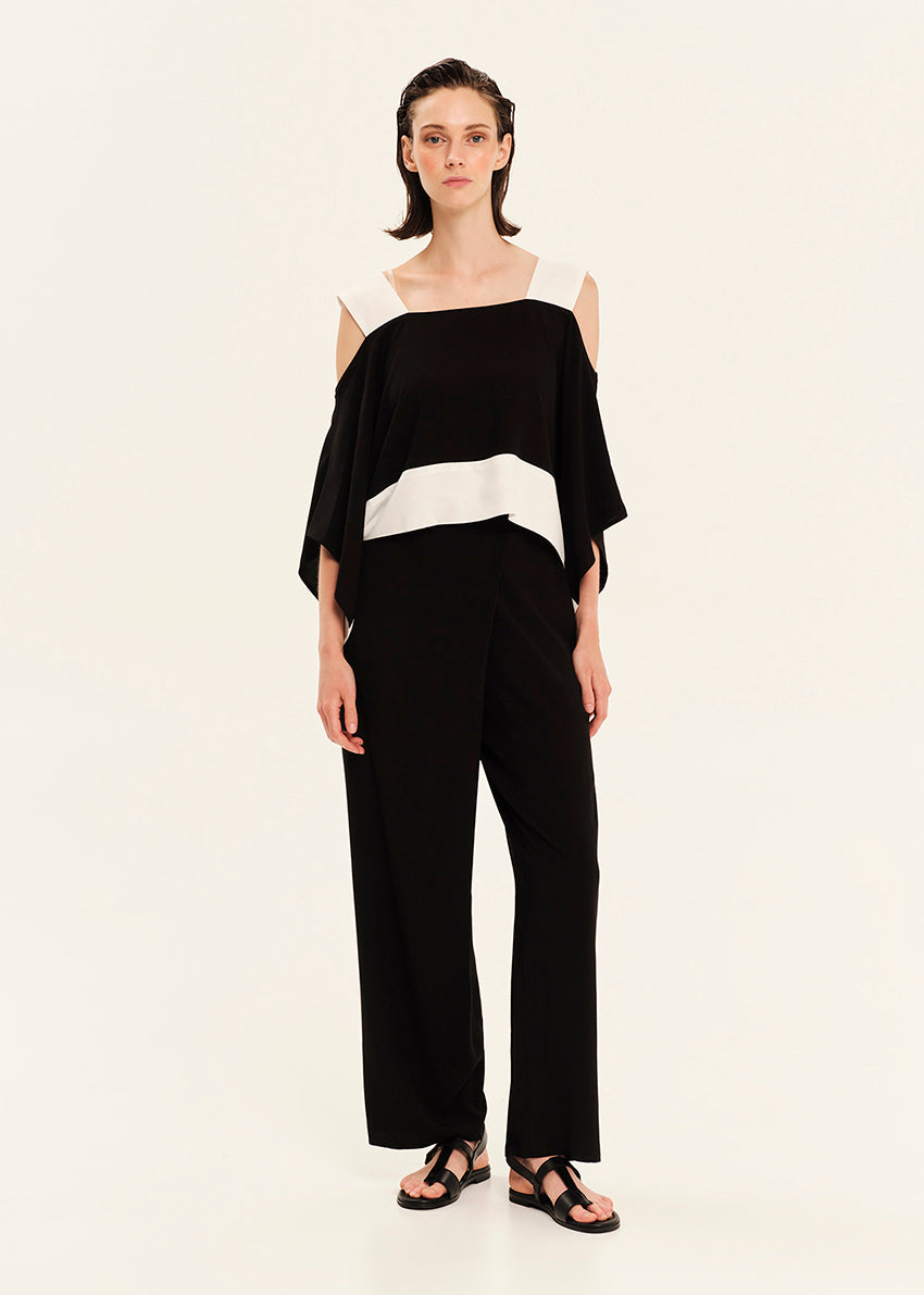 Woman wearing a black and white outfit on a white background
