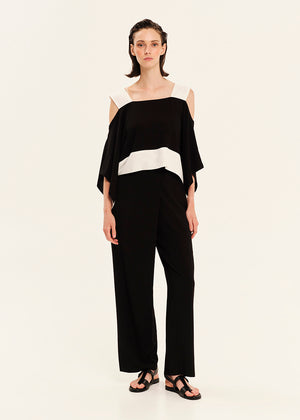 Woman wearing a black and white outfit on a white background