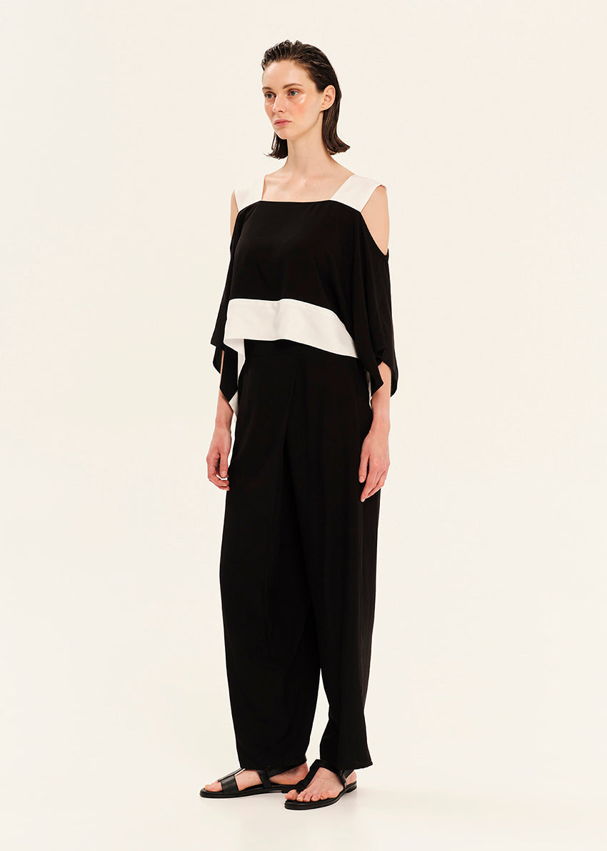 Woman wearing a black and white outfit on a white background