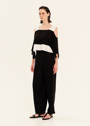 Woman wearing a black and white outfit on a white background