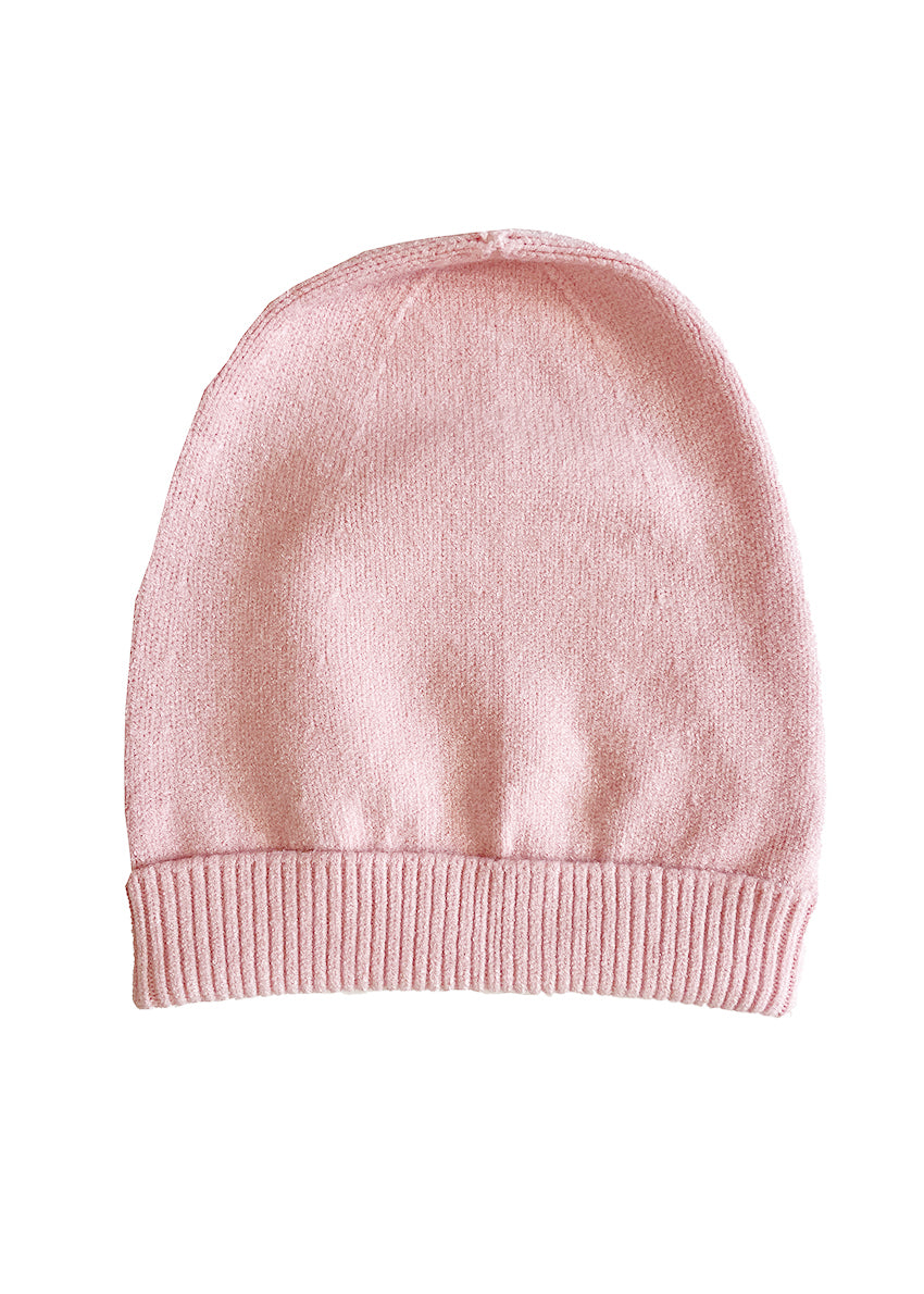 Light pink warm beanie on a white background