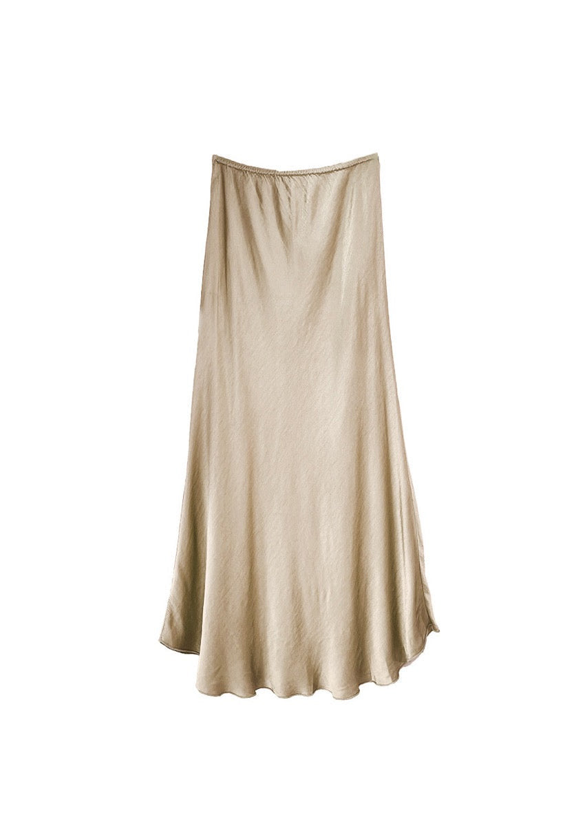 A beige satin midi-length skirt with a high-rise waist and a flaring hem.