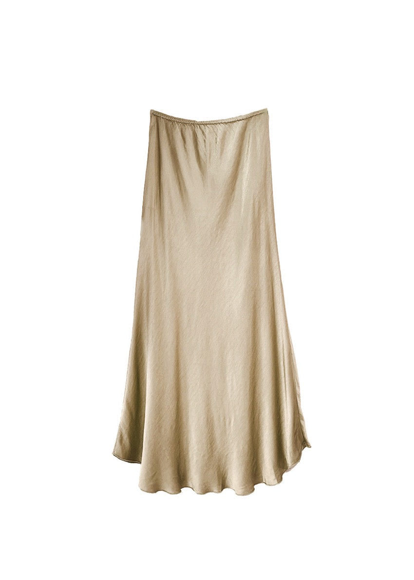 A tan satin midi-length skirt with a high-rise waist and a flaring hem.