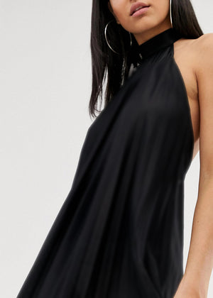 Black sleeveless dress worn by a model on a white background