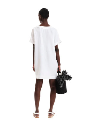 White tunic with front detail made of a linen and bamboo blend with a linen look.It has a boxy shape with short sleeves and mini length. It has a plunging “V” neck with ribbons that tie in “X” shapes while the fringes at the seams highlight its raw look.