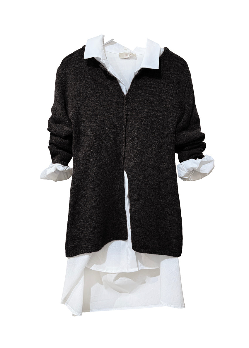 Black sweater over a white shirt on a white background