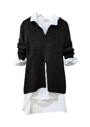 Black sweater over a white shirt on a white background
