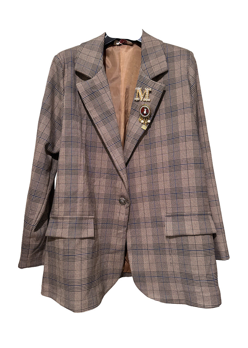Plaid blazer with decorative pins on a white background