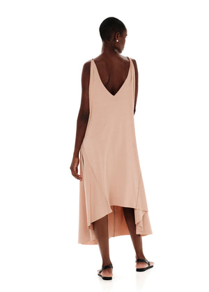Dark salmon asymmetrical sleeveless dress, crafted from eco-friendly elastic EcoVero viscose. Featuring a relaxed fit and a soft, cozy texture. Its unique design includes a V-shaped back, which can be reversed for a boat neckline in front.