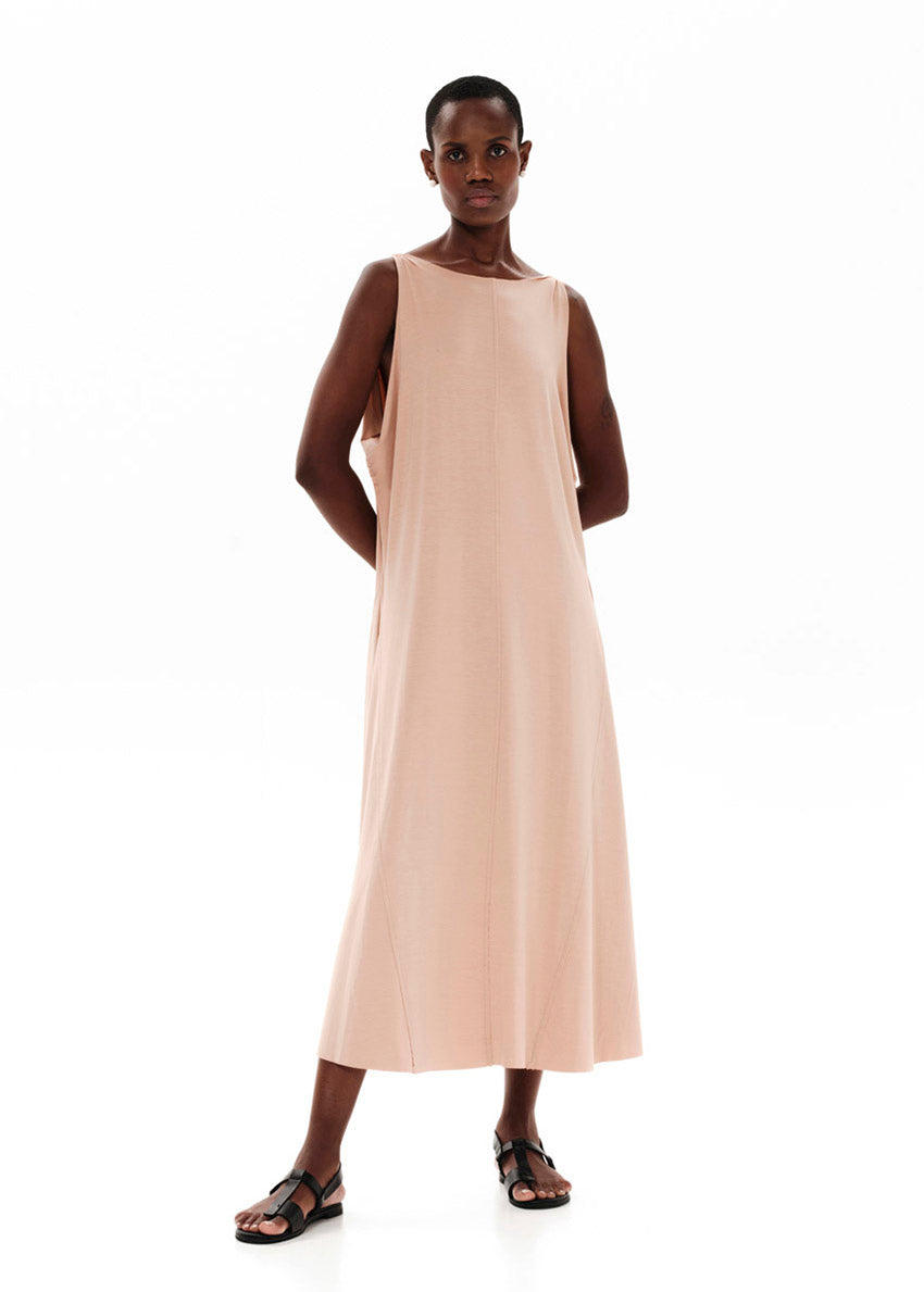 Dark salmon asymmetrical sleeveless dress, crafted from eco-friendly elastic EcoVero viscose. Featuring a relaxed fit and a soft, cozy texture. Its unique design includes a V-shaped back, which can be reversed for a boat neckline in front.