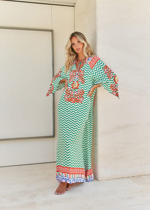 Femme and floral, this forever timeless maxi dress - inspired maxi is featured in a flowy, pintucked back and shoulder silhouette with button-front detailing, tassle and subtle scarf sleeve.