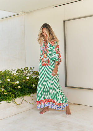 Femme and floral, this forever timeless maxi dress - inspired maxi is featured in a flowy, pintucked back and shoulder silhouette with button-front detailing, tassle and subtle scarf sleeve.