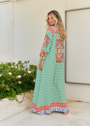 Femme and floral, this forever timeless maxi dress - inspired maxi is featured in a flowy, pintucked back and shoulder silhouette with button-front detailing, tassle and subtle scarf sleeve.