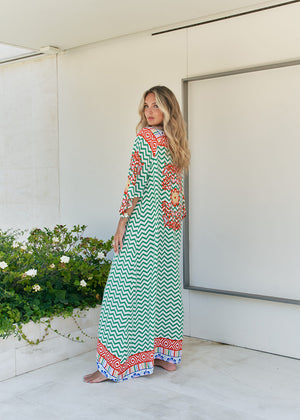 Femme and floral, this forever timeless maxi dress - inspired maxi is featured in a flowy, pintucked back and shoulder silhouette with button-front detailing, tassle and subtle scarf sleeve.
