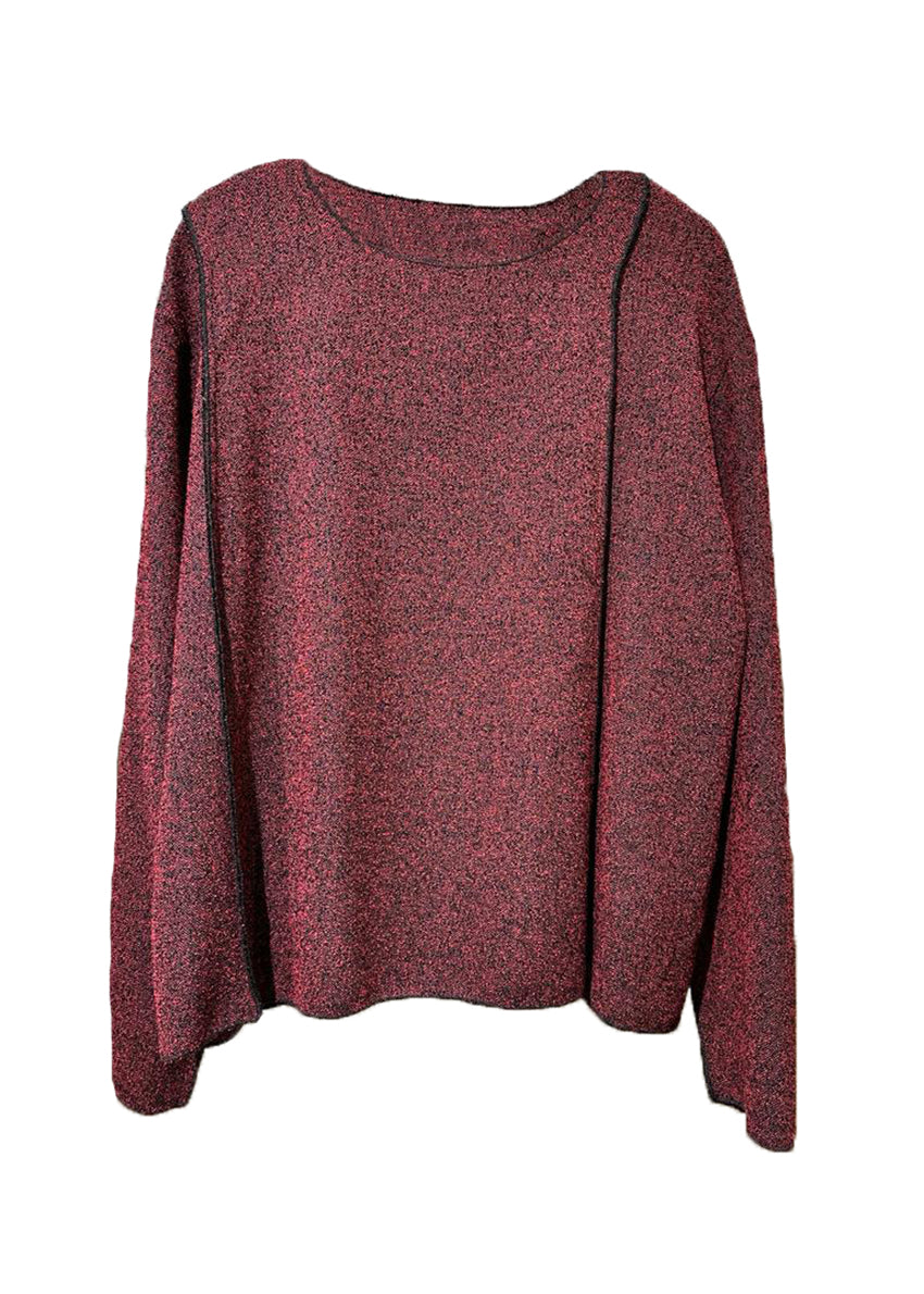 A red unisex top with a crepe texture, featuring a relaxed fit with slightly dropped shoulders and diagonal seams along the upper sleeves.