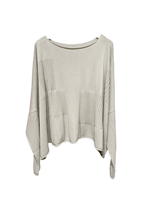 otton knitted top. It has long sleeves and an oversized boat neckline that can be worn on both sides for added versatility