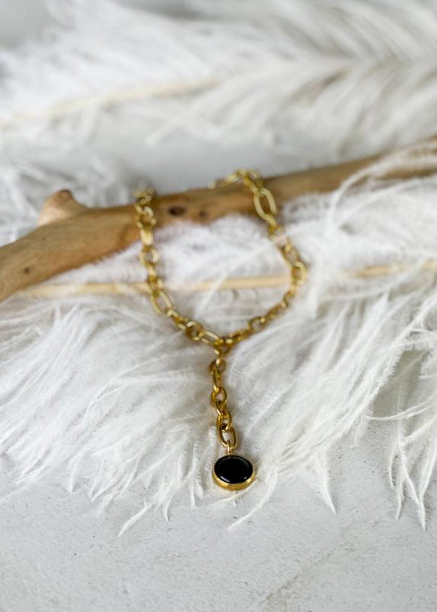 Babbett anklet, crafted with gold plating and accented by a striking black onyx stone