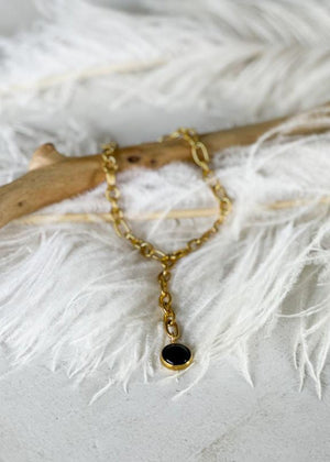 Babbett anklet, crafted with gold plating and accented by a striking black onyx stone