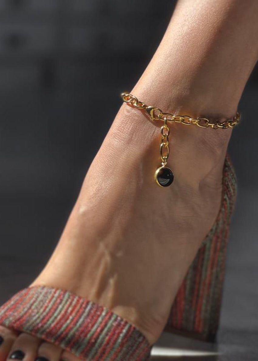 Babbett anklet, crafted with gold plating and accented by a striking black onyx stone