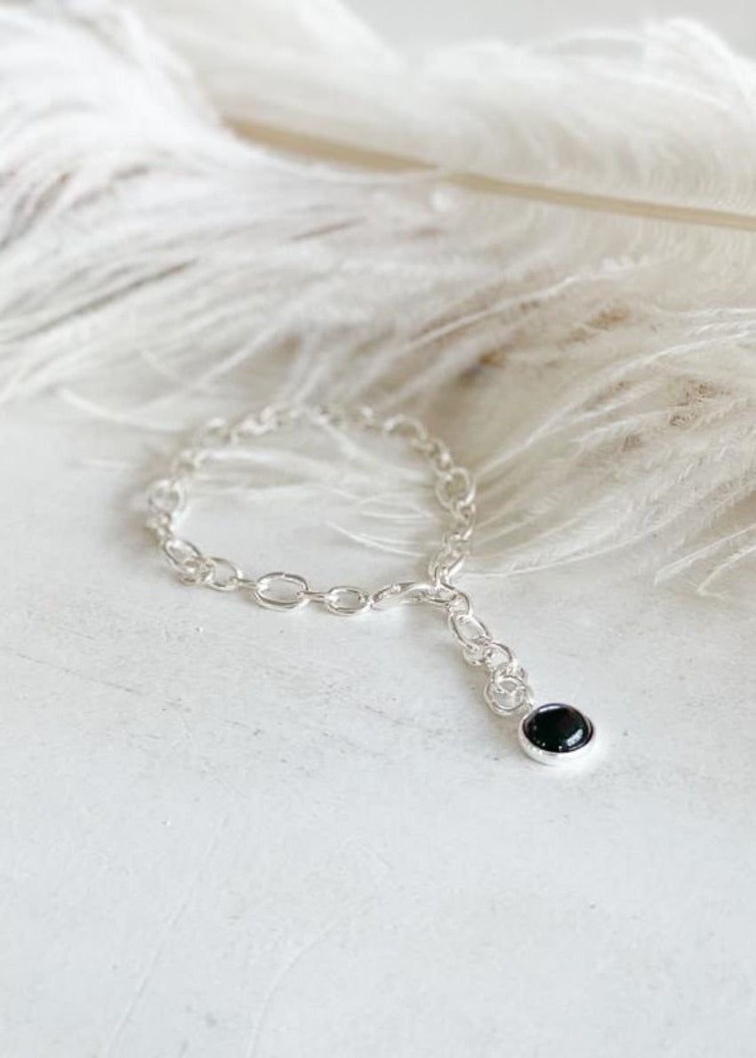 Babbett anklet, crafted with gold plating and accented by a striking black onyx stone