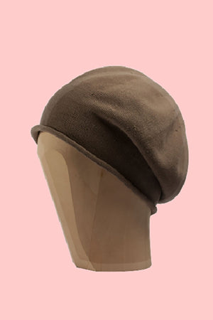 Tan beanie beret on a pink background 