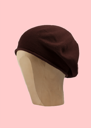 Brown beanie beret on a pink background 