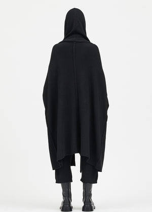 Person wearing a black cardigan on a white background