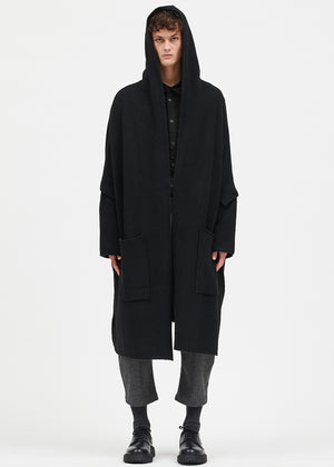 Person wearing a black cardigan on a white background