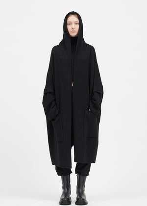 Person wearing a black cardigan on a white background