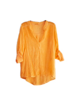 A orange shirt on a white background 