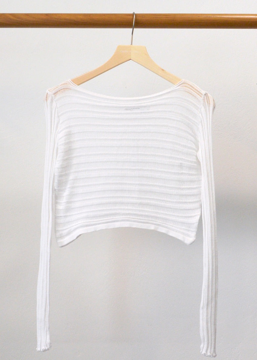 Knitted long sleeved crop top with the “Archetypes” rib pattern and yarn made of 100% high quality Greek cotton, in a fitted silhouette. It has a boat neckline.