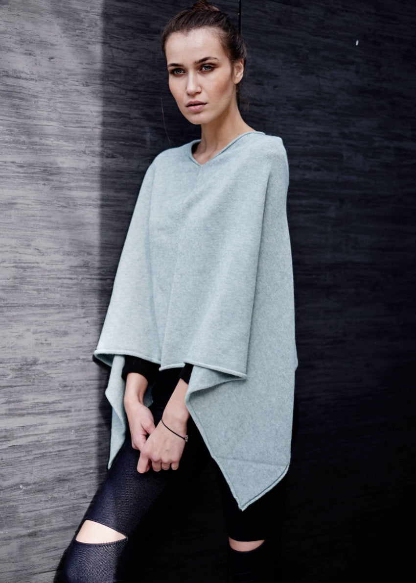 A person wearing a light grey poncho