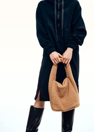 Furry purse made of wool blend fabric. A fashion statement design, it closes with a metallic clasp and it is fully lined.