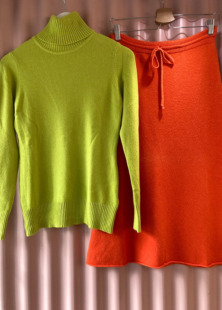 Green sweater with orange skirt